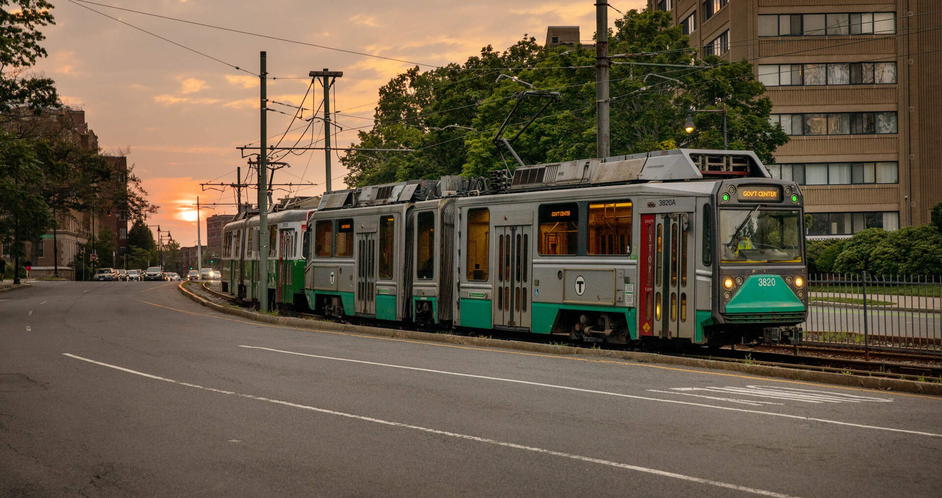The Green Line B branch pulling through Comm Ave at sunset